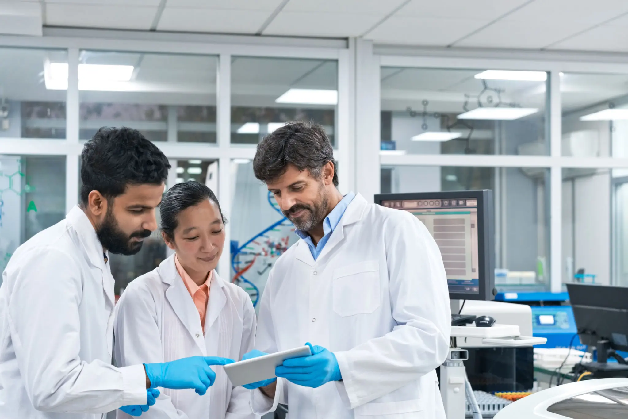 Lab team reviewing data on tablet