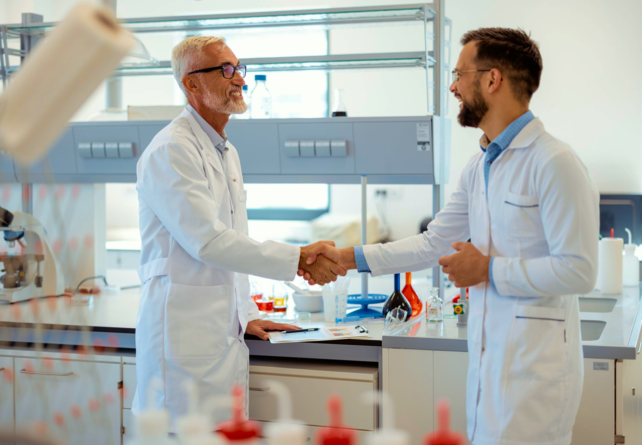 Researchers greeting in lab coats